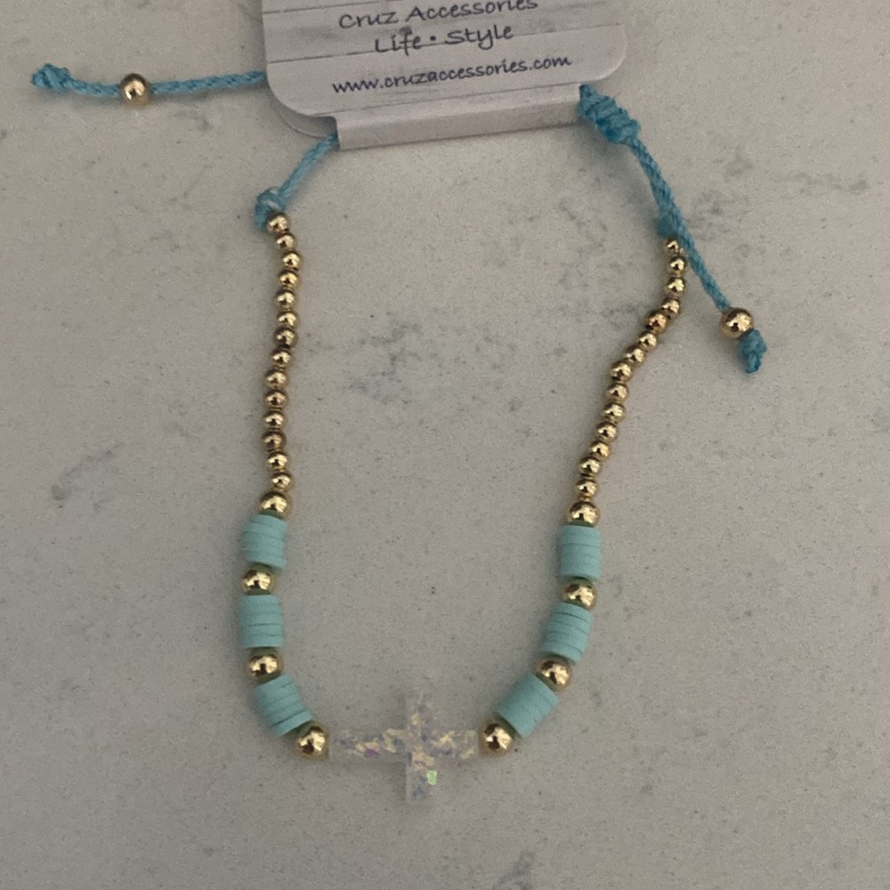 Gold and Blue Beaded adjustable Bracelet w white iridescent cross NWT.